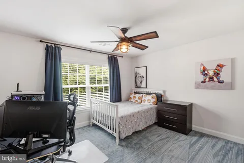 a bathroom with a granite countertop sink toilet mirror vanity and shower