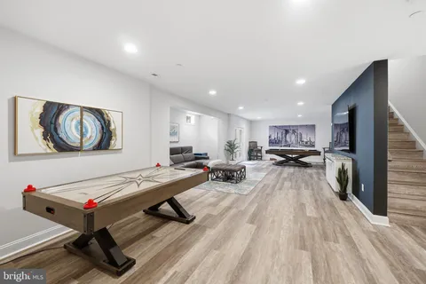 a room with furniture pool table and view living room