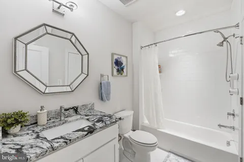 a view of a patio with a table and chairs under an umbrella