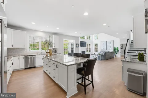 a kitchen with sink cabinets and wooden floor