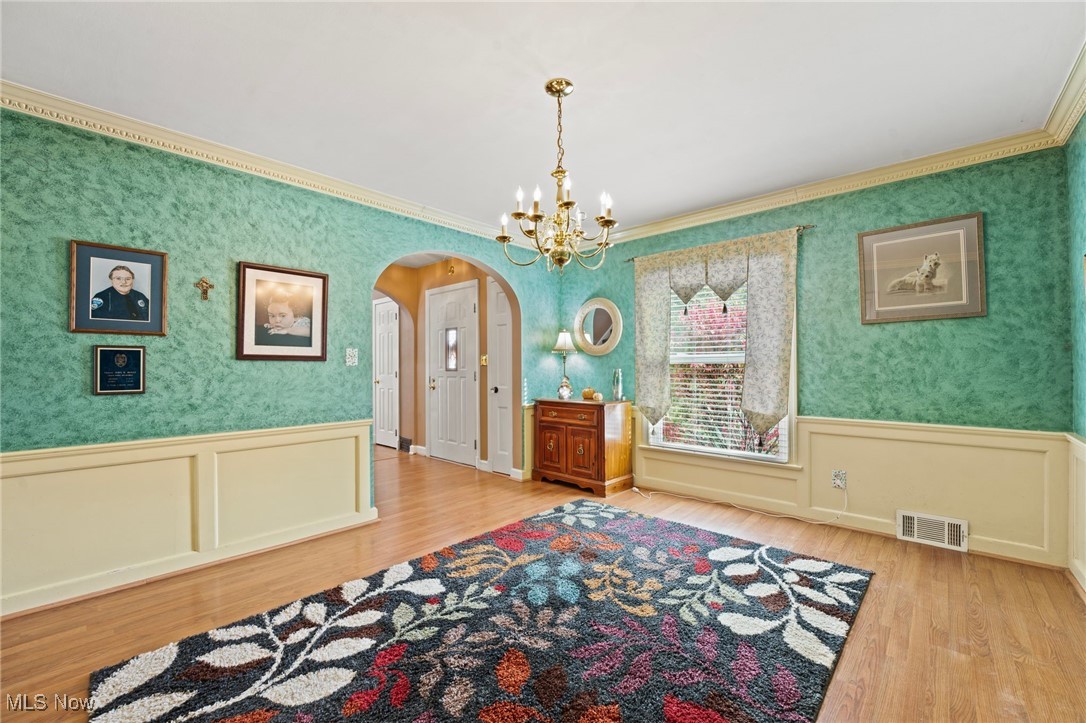 360 Sand Run Road Akron, OH 44313 - Photo 13 of 44 Formal Dining Room's arched doorway, wainscoting and crown molding add timeless appeal.