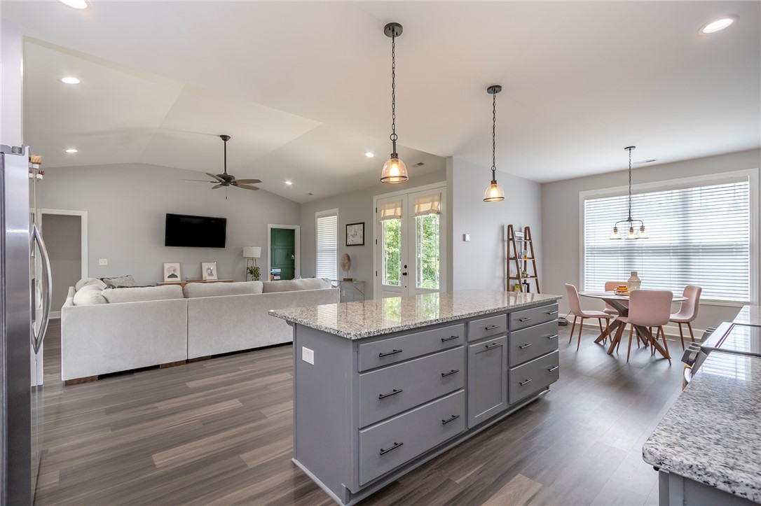 3080 McGee Road Iva, SC 29655 - Photo 48 of 49 An open floorplan seamlessly connects the kitchen, dining, and living areas for modern entertaining.
