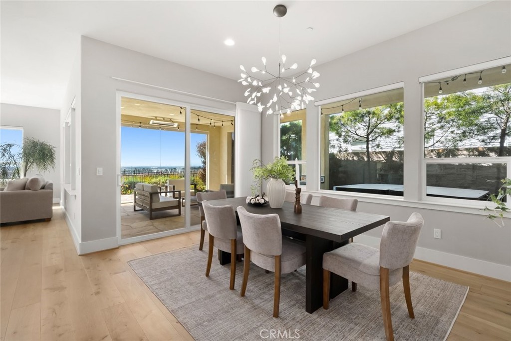 1590 Eucalyptus Road Nipomo, CA 93444 - Photo 15 of 75 a dining room with furniture a chandelier and wooden floor