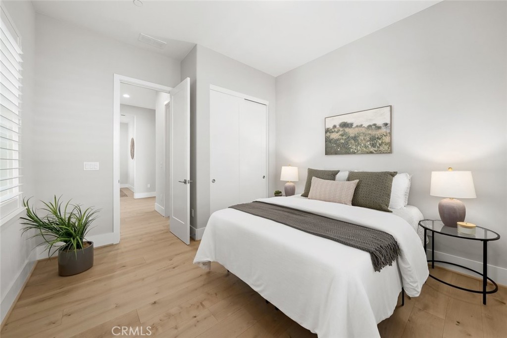 1590 Eucalyptus Road Nipomo, CA 93444 - Photo 35 of 75 a bedroom with a bed and a potted plant