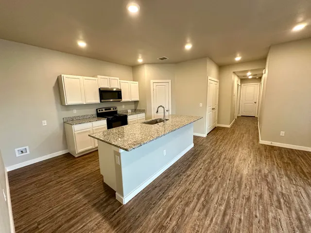 a bathroom with a granite countertop toilet a sink and a bathtub