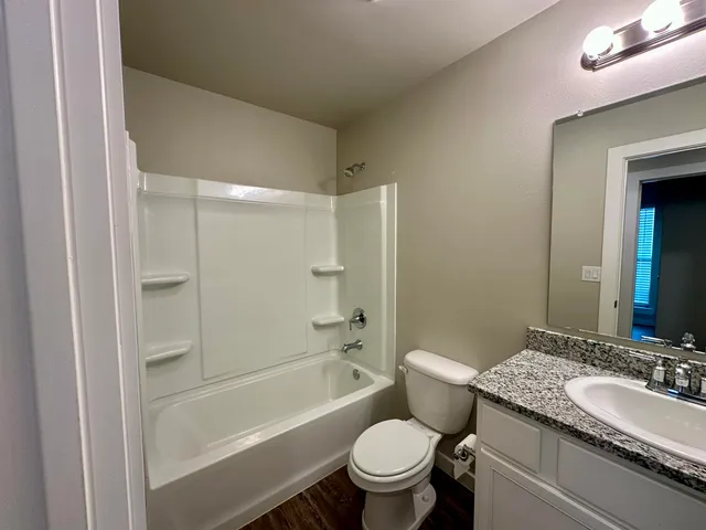 a view of a room with wooden floor and window