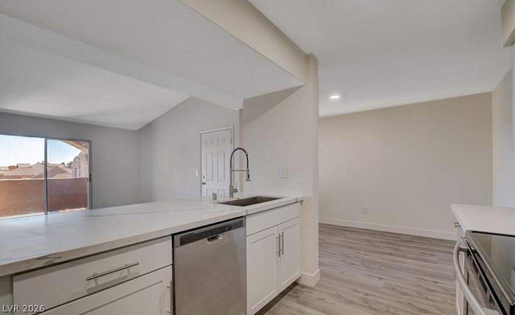 8101 West Flamingo Road, Unit 2014 Las Vegas, NV 89147 - Photo 12 of 13 An open floor plan connects the kitchen to surrounding living areas with durable wood-look flooring.