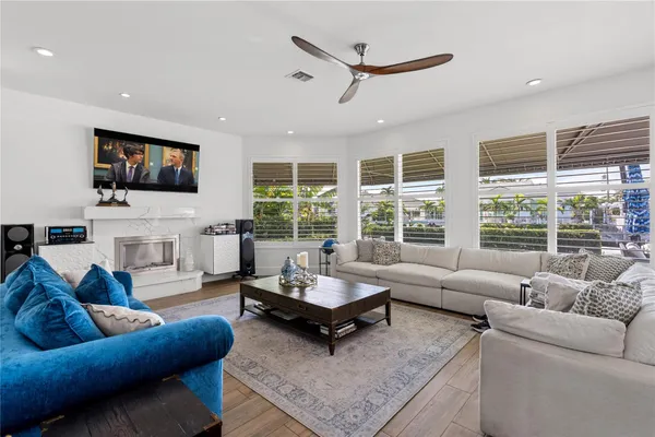 a living room with furniture and a floor to ceiling window