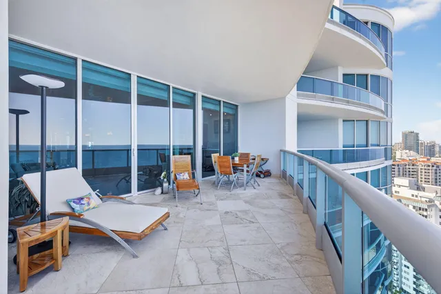 a view of dinning table and chairs in the balcony