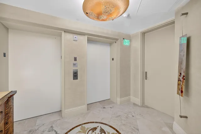 a bathroom with a granite countertop sink mirror vanity and toilet
