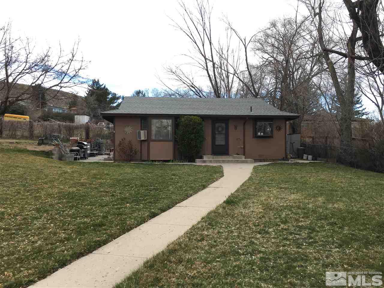 2230 Carter Drive Reno, NV 89509 - Photo 1 of 1 a front view of a house with a garden and trees