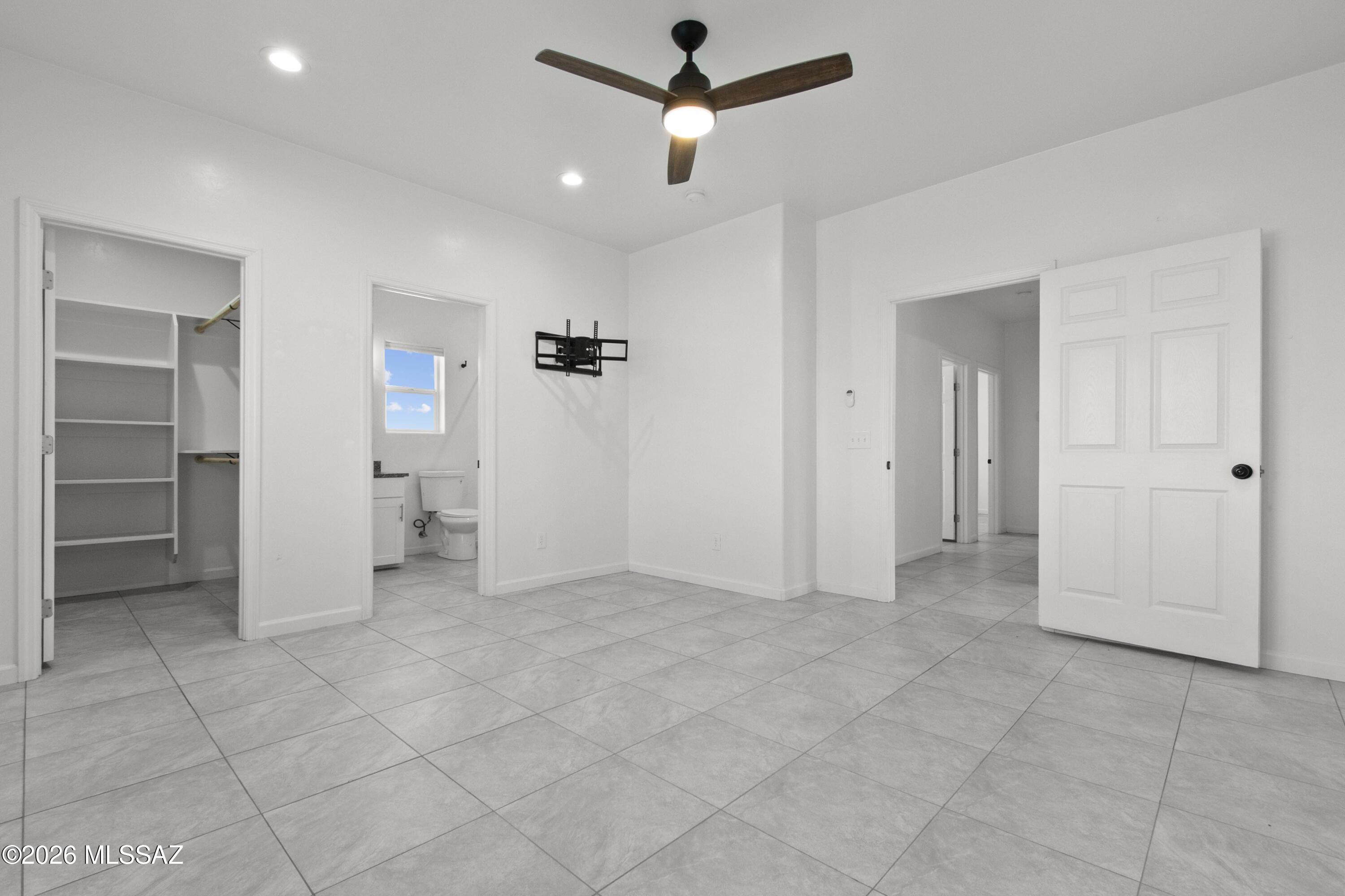 1785 Dove Court Rio Rico, AZ 85648 - Photo 16 of 31 an empty room with closet and a ceiling fan
