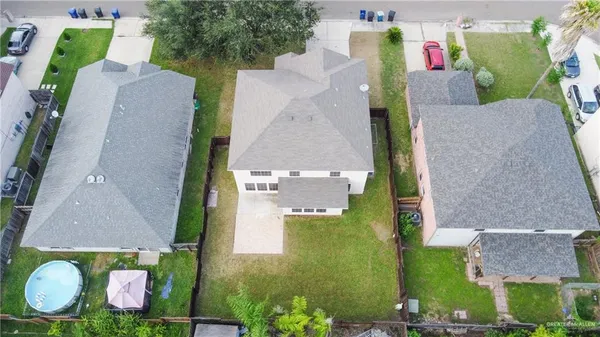 an aerial view of a house with a yard