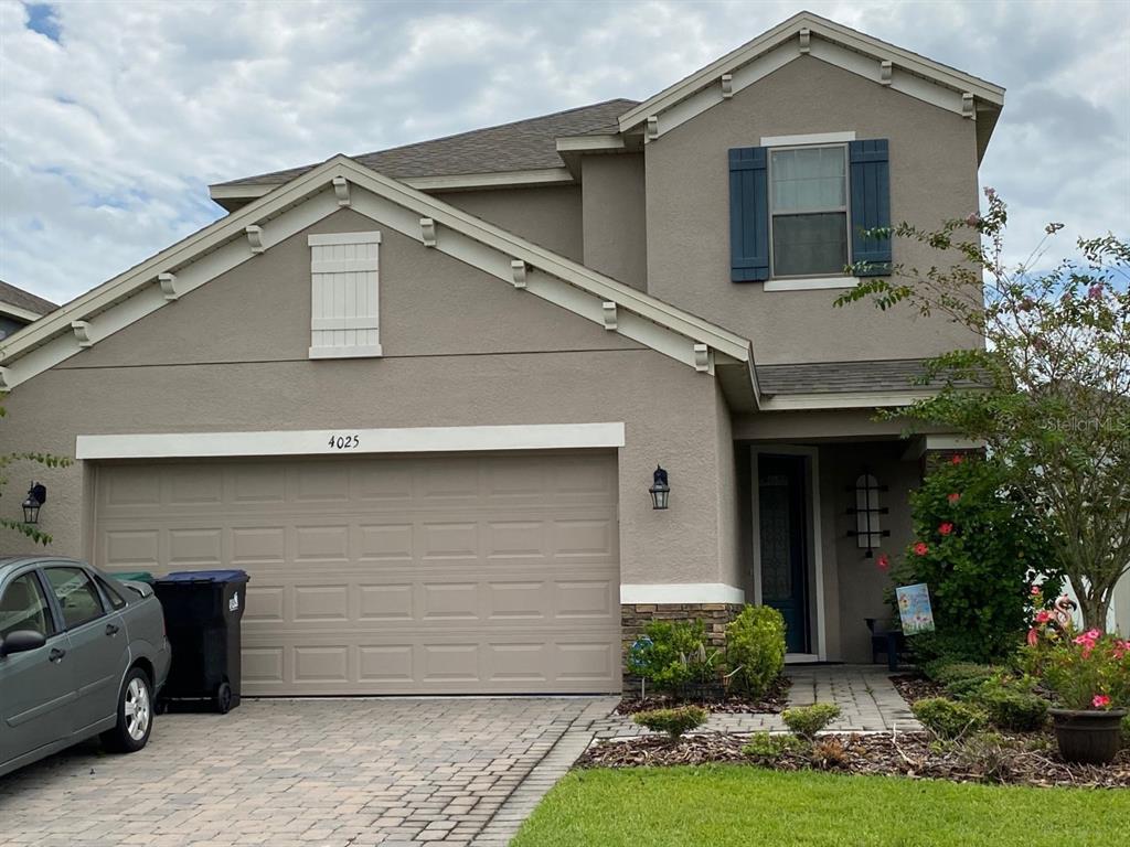 4025 Scarlet Branch Road Orlando, FL 32824 - Photo 1 of 1 a front view of a house with garden