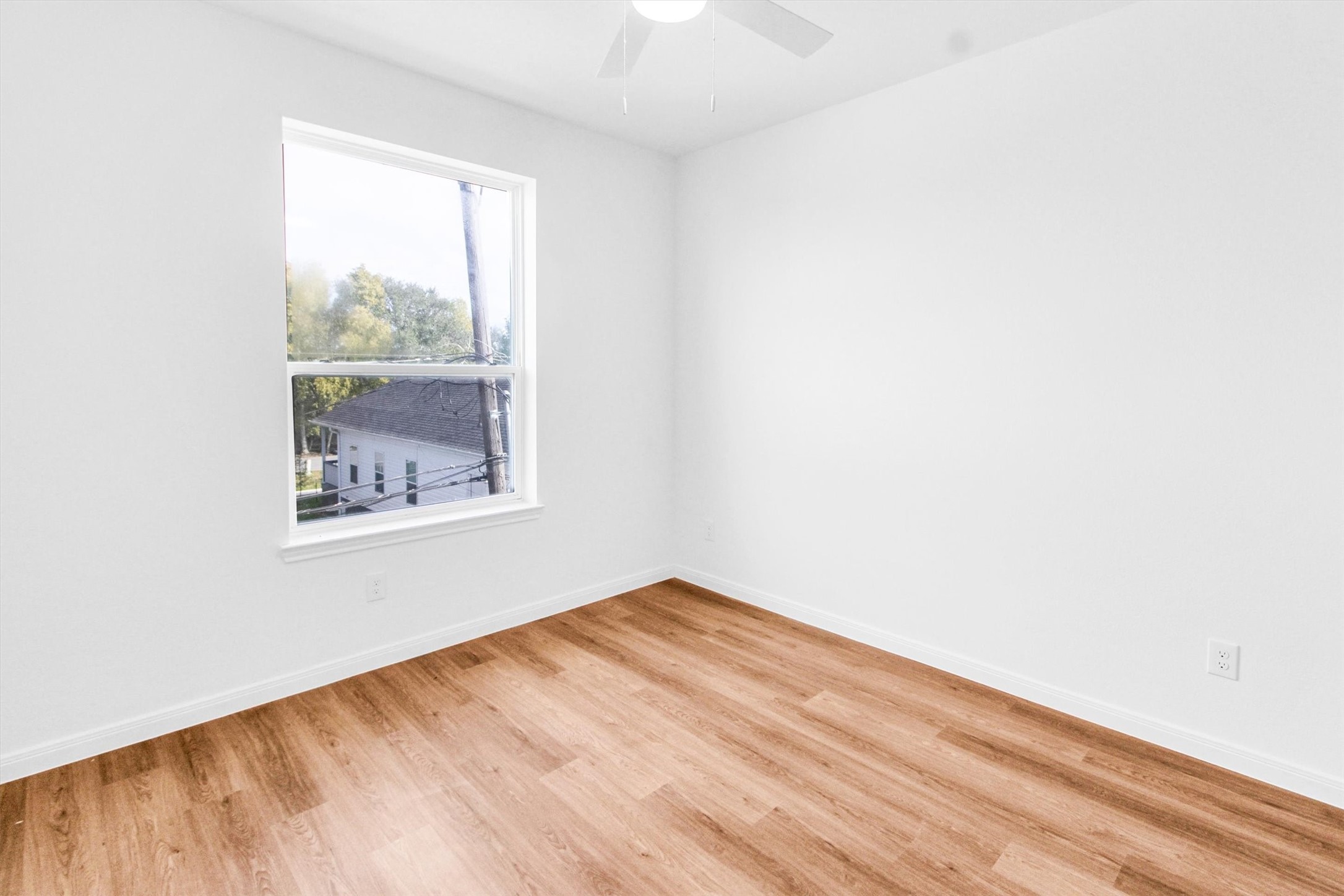 5325 Rue Street Houston, TX 77033 - Photo 29 of 34 a view of empty room with wooden floor and fan