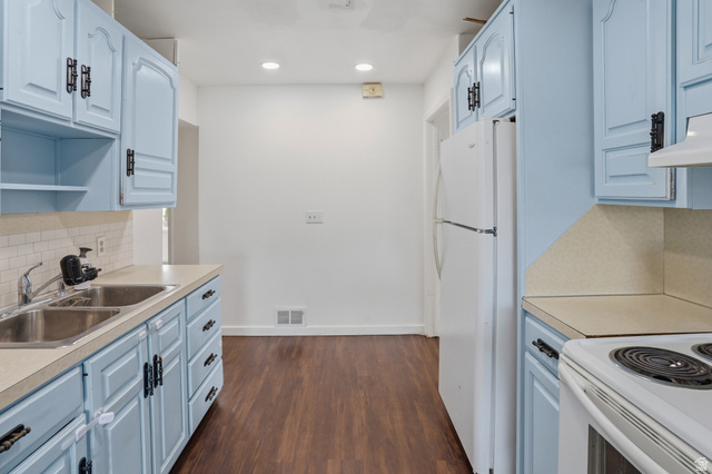 774 37th Street South Ogden, UT 84403 - Photo 7 of 47 Kitchen featuring light blue cabinetry with dark hardware, a dual basin stainless steel sink, and wood-finish flooring