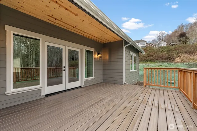 a view of backyard with deck and wooden floor