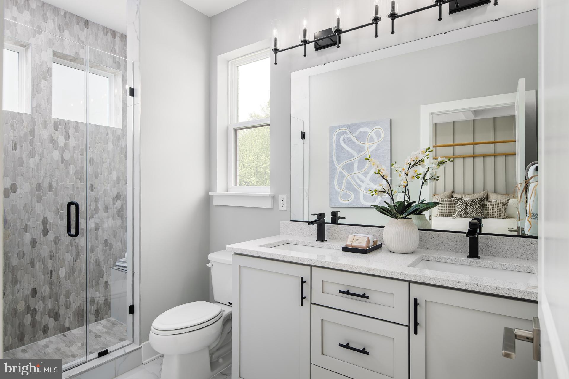 242 Light Street Baltimore, MD 21230 - Photo 10 of 29 a bathroom with a granite countertop sink a toilet and shower