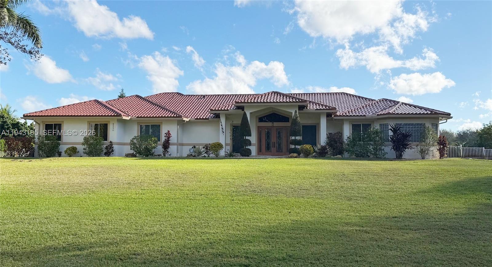 a front view of a house with a garden