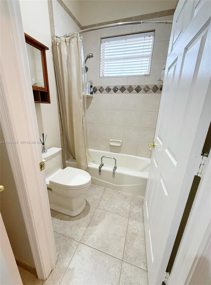 6550 Southwest 183rd Way Southwest Ranches, FL 33331 - Photo 14 of 24 a bathroom with a granite countertop sink a toilet a mirror and shower