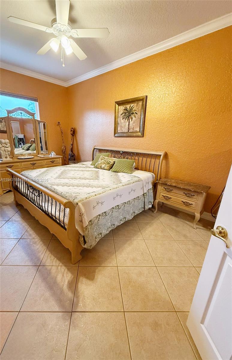 6550 Southwest 183rd Way Southwest Ranches, FL 33331 - Photo 15 of 24 a spacious bedroom with a bed and a chandelier