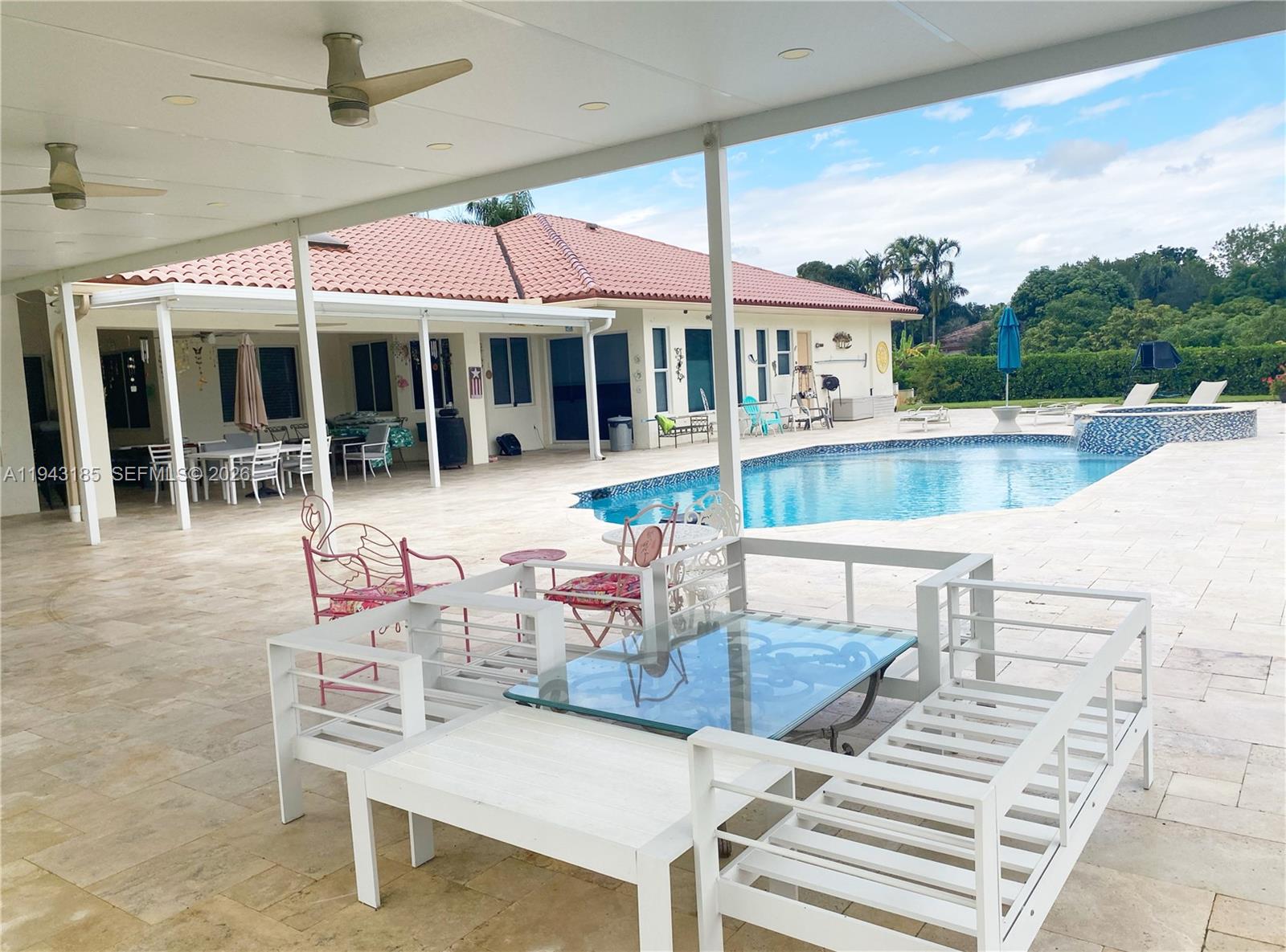 6550 Southwest 183rd Way Southwest Ranches, FL 33331 - Photo 20 of 24 a view of a patio with table and chairs with wooden floor and fence