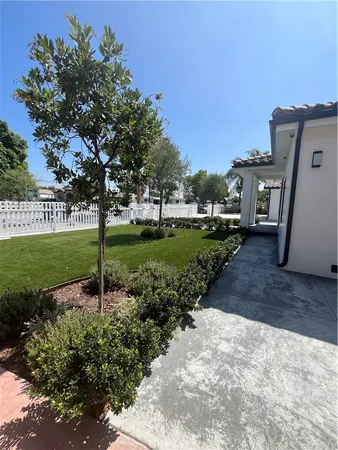 a view of a garden with a house in the background