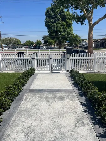 a view of a yard with wooden fence