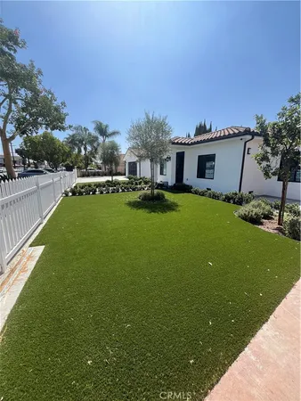 a house view with swimming pool in front of it