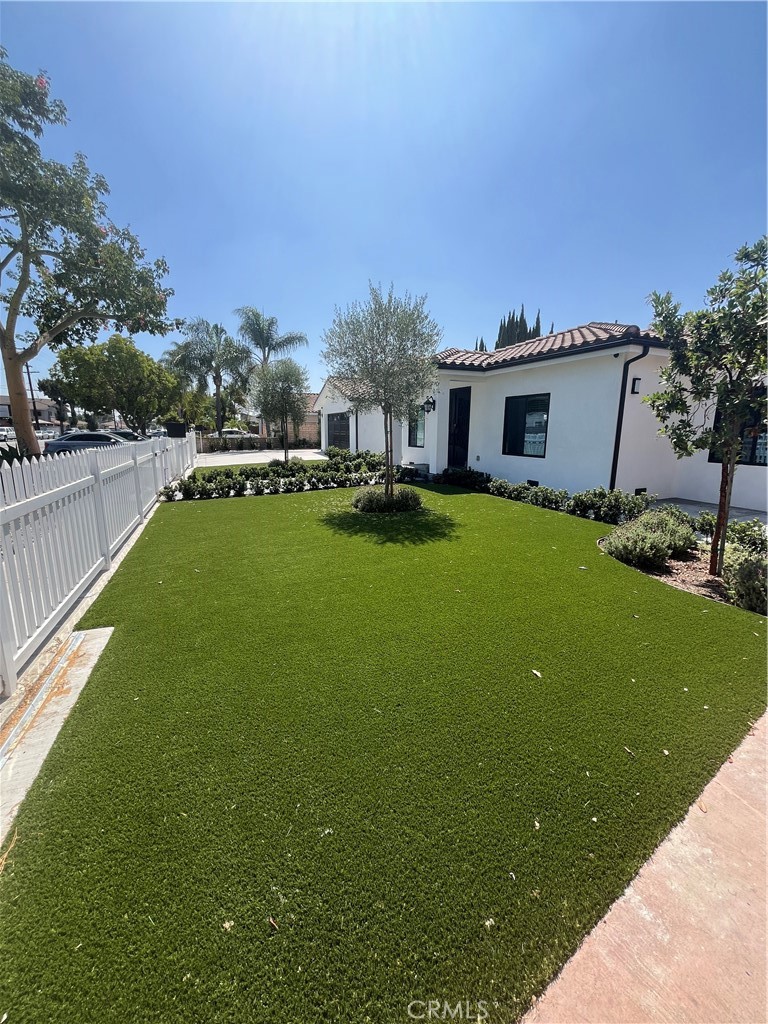7274 Century Paramount, CA 90723 - Photo 6 of 11 a house view with swimming pool in front of it