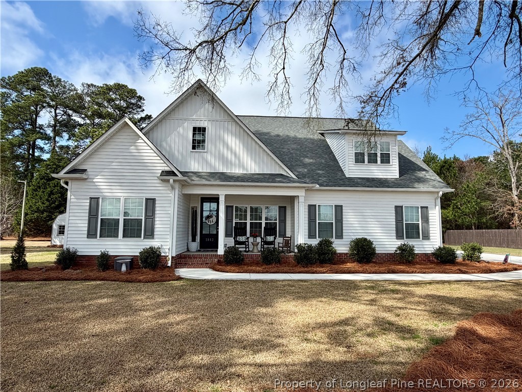 1843 Meadow Road Lumberton, NC 28358 - Photo 1 of 35 a front view of a house with lots of trees and plants