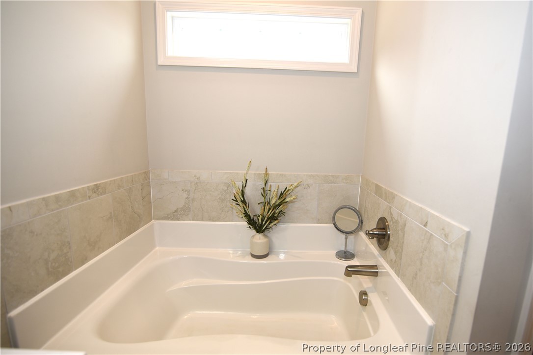 1843 Meadow Road Lumberton, NC 28358 - Photo 15 of 35 a bath tub sitting next to a white sink
