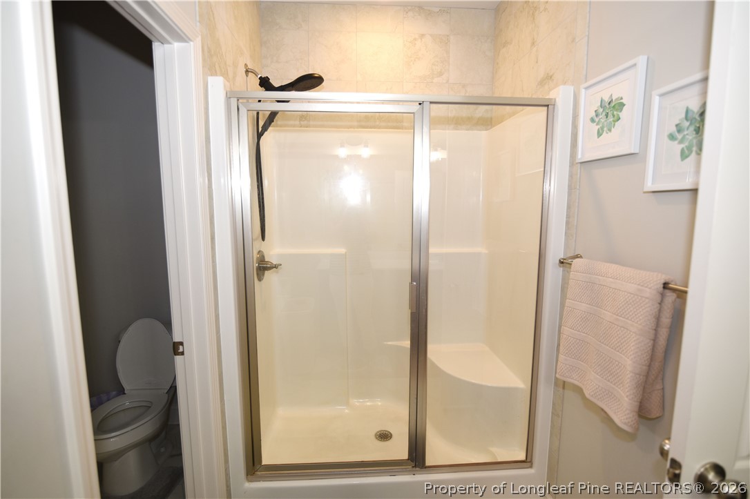 1843 Meadow Road Lumberton, NC 28358 - Photo 16 of 35 a bathroom with a glass shower door