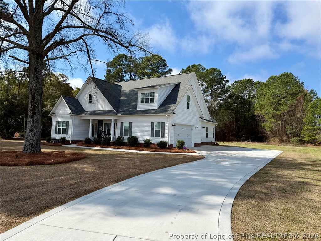 1843 Meadow Road Lumberton, NC 28358 - Photo 2 of 35 a front view of a house with a yard and garage