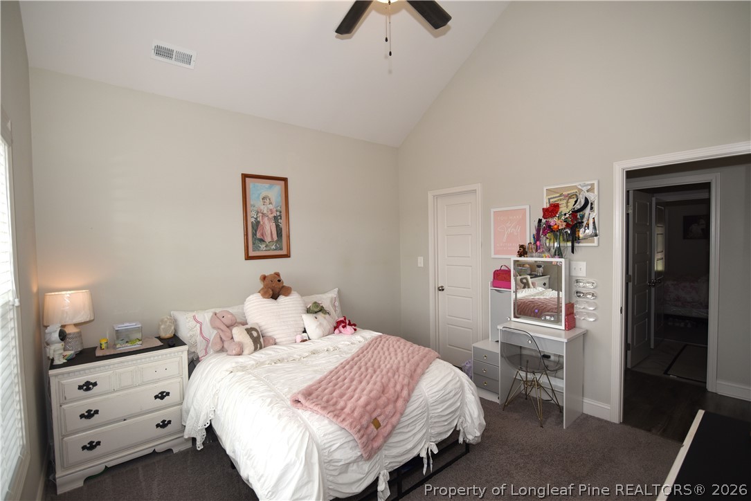 1843 Meadow Road Lumberton, NC 28358 - Photo 22 of 35 a bedroom with a bed and a chandelier