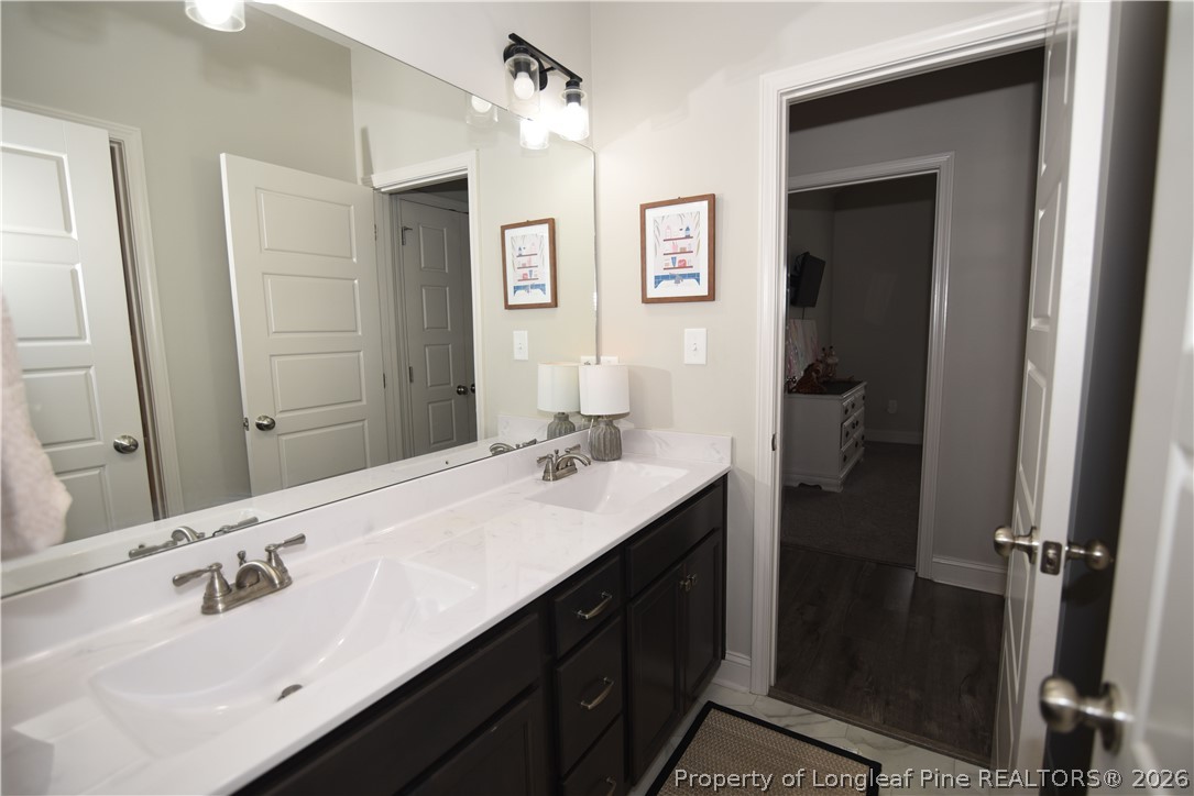 1843 Meadow Road Lumberton, NC 28358 - Photo 23 of 35 a bathroom with a double vanity sink and mirror