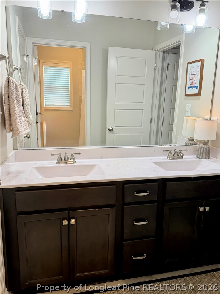 1843 Meadow Road Lumberton, NC 28358 - Photo 24 of 35 a bathroom with a sink and a mirror