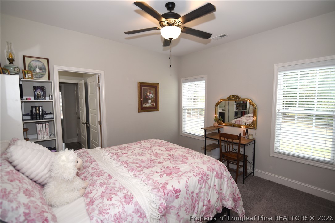 1843 Meadow Road Lumberton, NC 28358 - Photo 26 of 35 a bedroom with a bed and a chandelier