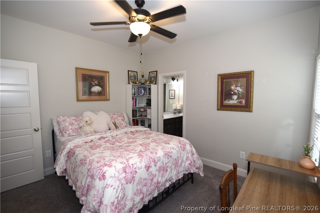 1843 Meadow Road Lumberton, NC 28358 - Photo 27 of 35 a bedroom with a bed and a chandelier