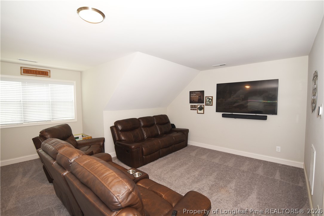 1843 Meadow Road Lumberton, NC 28358 - Photo 28 of 35 a living room with furniture and a flat screen tv