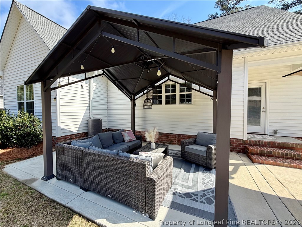 1843 Meadow Road Lumberton, NC 28358 - Photo 34 of 35 a outdoor space with patio couches and a potted plant