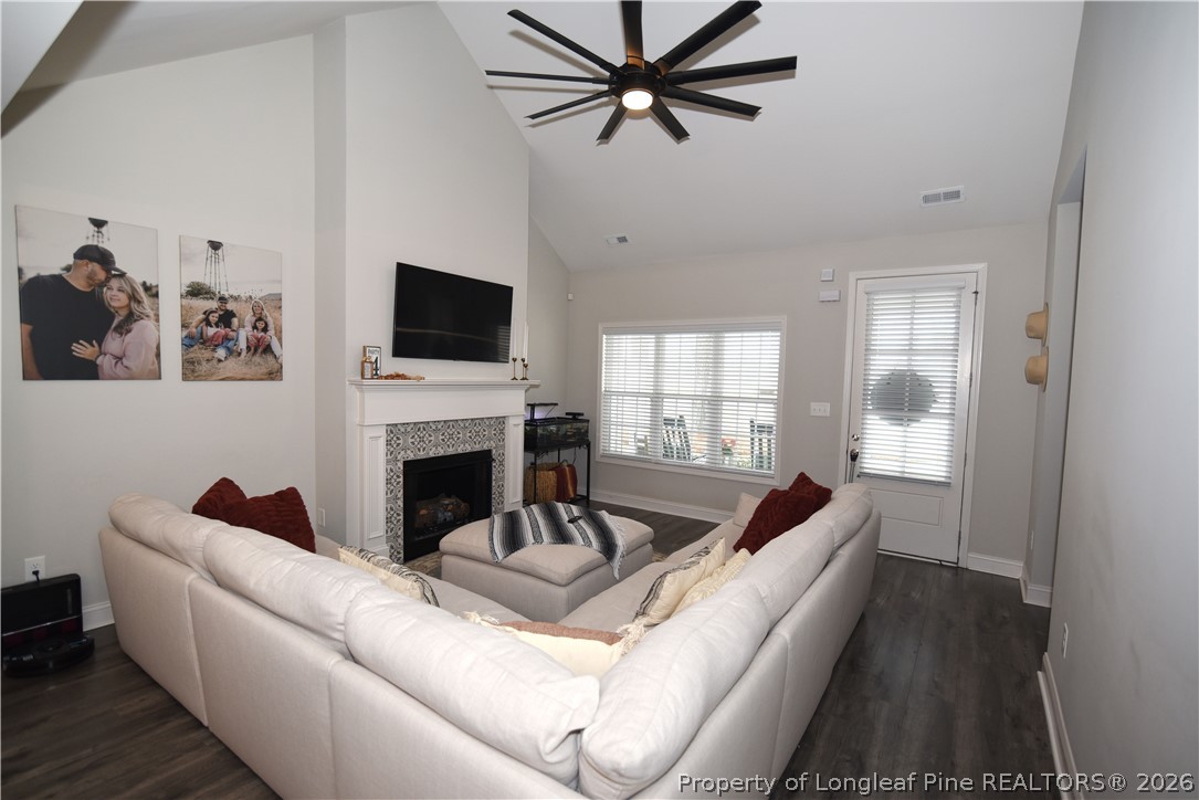 1843 Meadow Road Lumberton, NC 28358 - Photo 6 of 35 a living room with furniture a fireplace and a flat screen tv