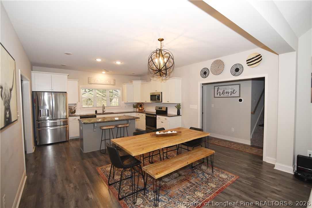 1843 Meadow Road Lumberton, NC 28358 - Photo 9 of 35 a living room with stainless steel appliances kitchen island granite countertop furniture wooden floor and a window