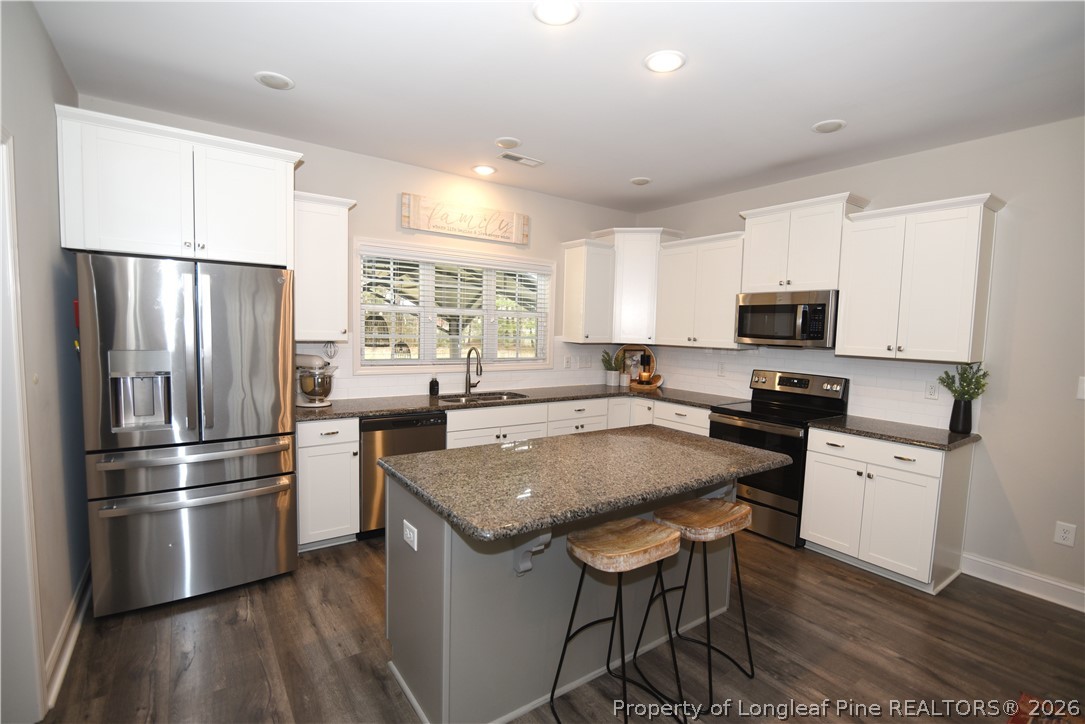1843 Meadow Road Lumberton, NC 28358 - Photo 10 of 35 a kitchen with granite countertop a refrigerator stove microwave and cabinets