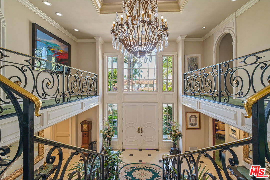 511 North Canon Drive Beverly Hills, CA 90210 - Photo 20 of 34 a view of a hallway with paintings on the wall
