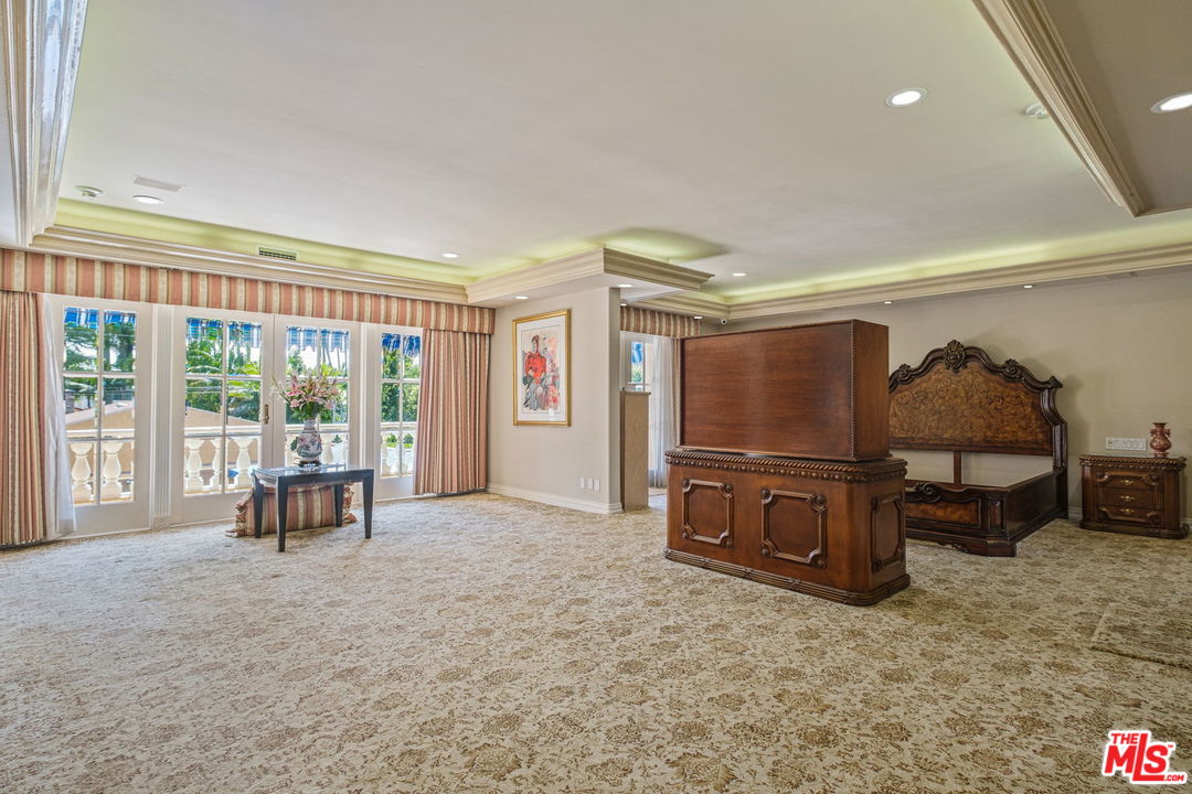 511 North Canon Drive Beverly Hills, CA 90210 - Photo 22 of 34 a living room with furniture and a flat screen tv