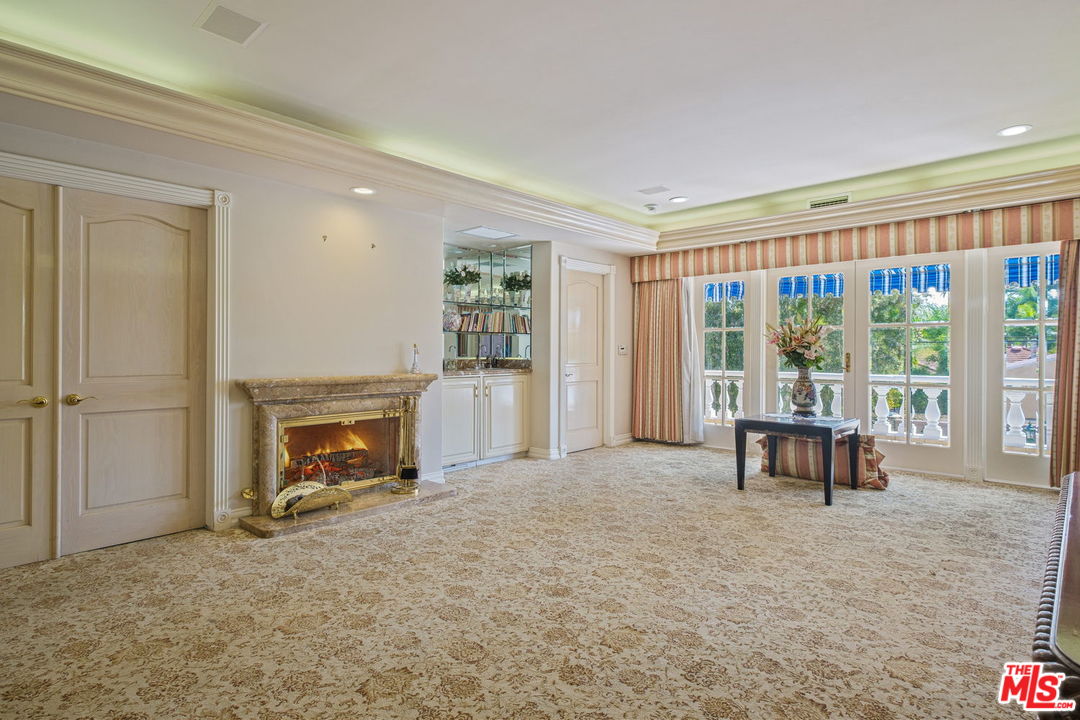 511 North Canon Drive Beverly Hills, CA 90210 - Photo 23 of 34 a living room with furniture and a fireplace