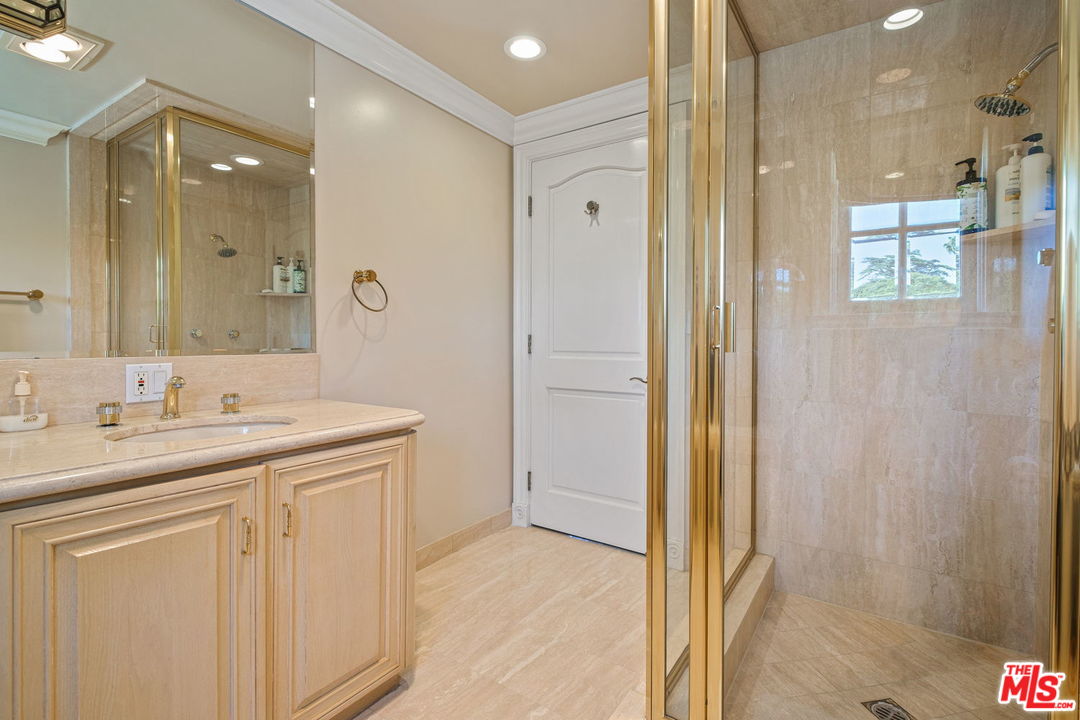 511 North Canon Drive Beverly Hills, CA 90210 - Photo 29 of 34 a bathroom with a sink and a mirror