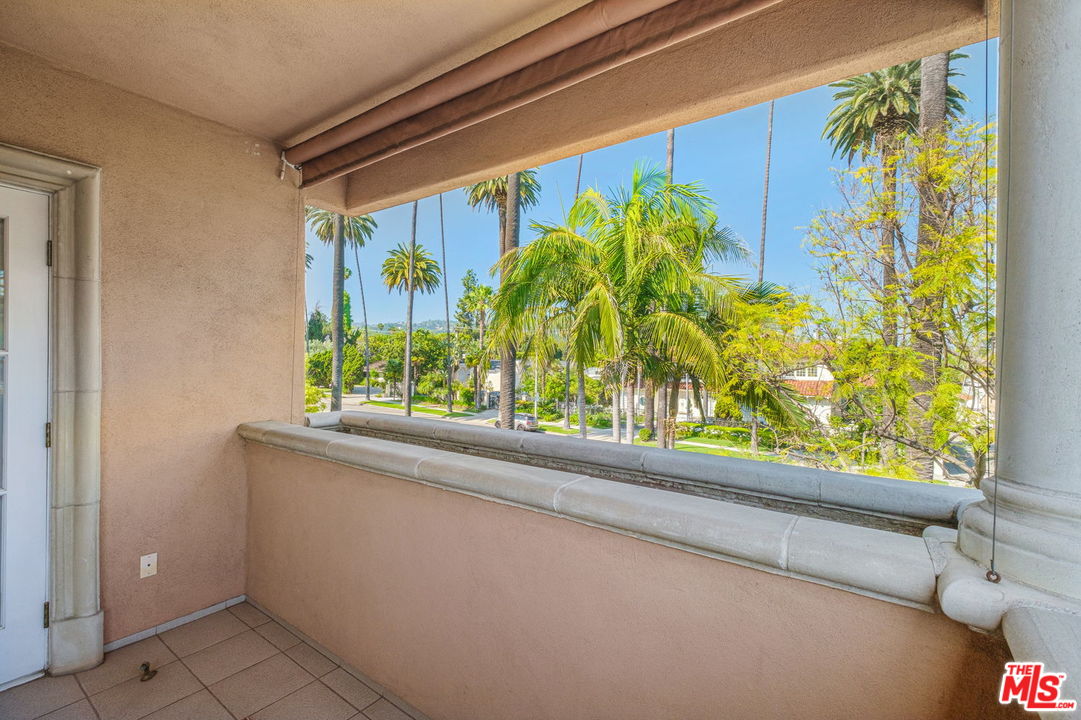 511 North Canon Drive Beverly Hills, CA 90210 - Photo 30 of 34 a window with a plant in front of it