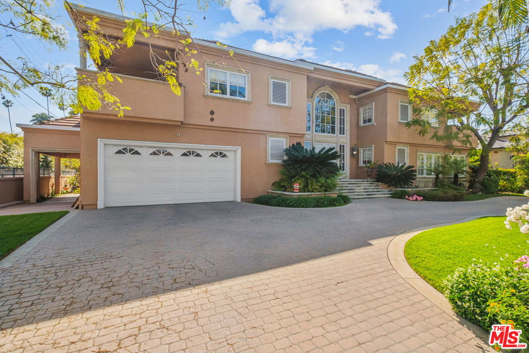511 North Canon Drive Beverly Hills, CA 90210 - Photo 3 of 34 a view of a white apartments with large windows